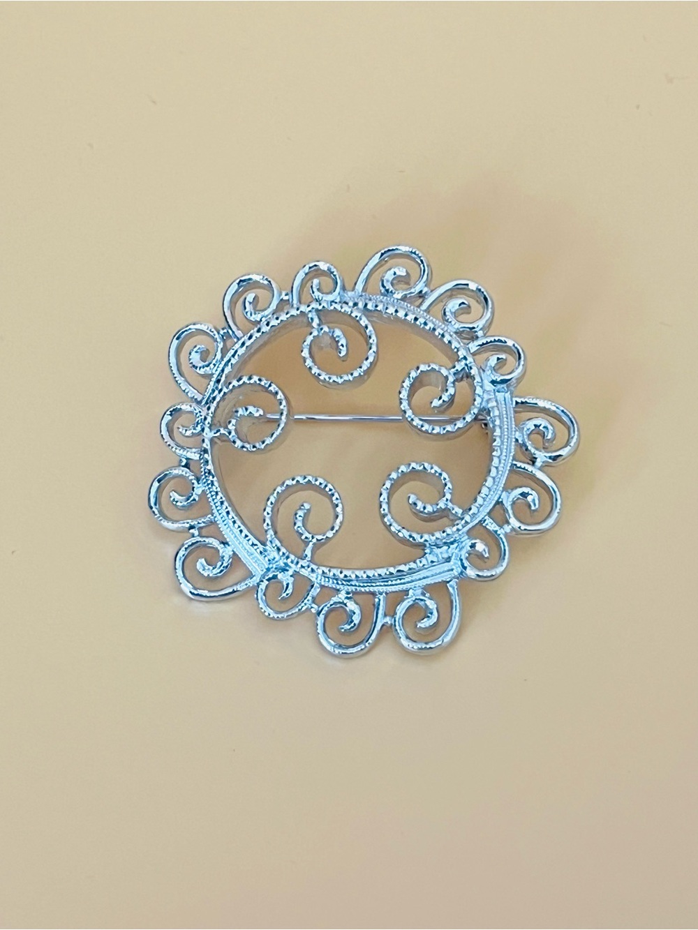 Vintage silver tone swirl brooch signed Sarah Coventry